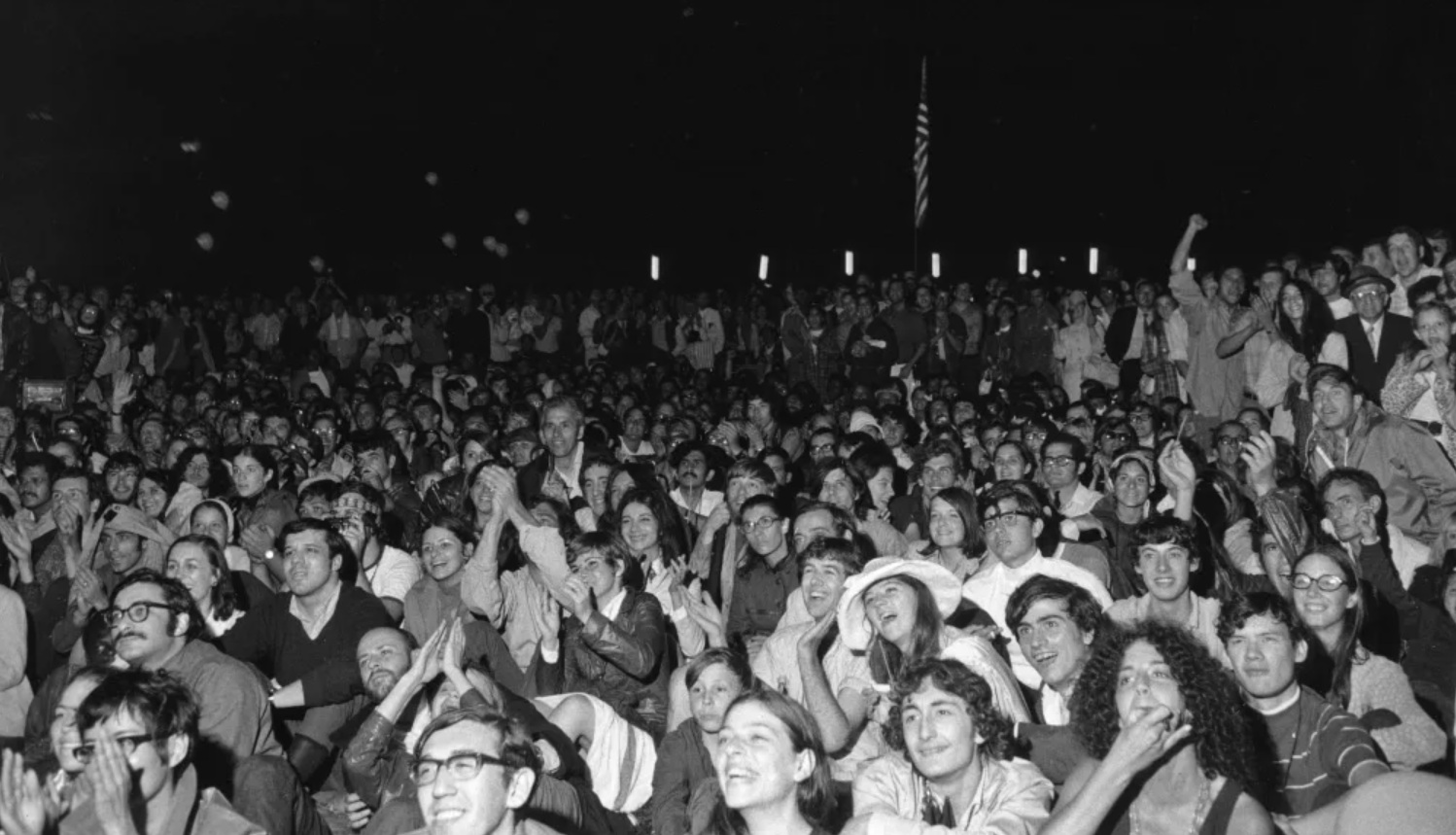 Roughly 10,000 people watched on a large television screen in New York's Central Park, cheering Neil Armstrong as he took his first steps on the moon on July 20, 1969. © Think